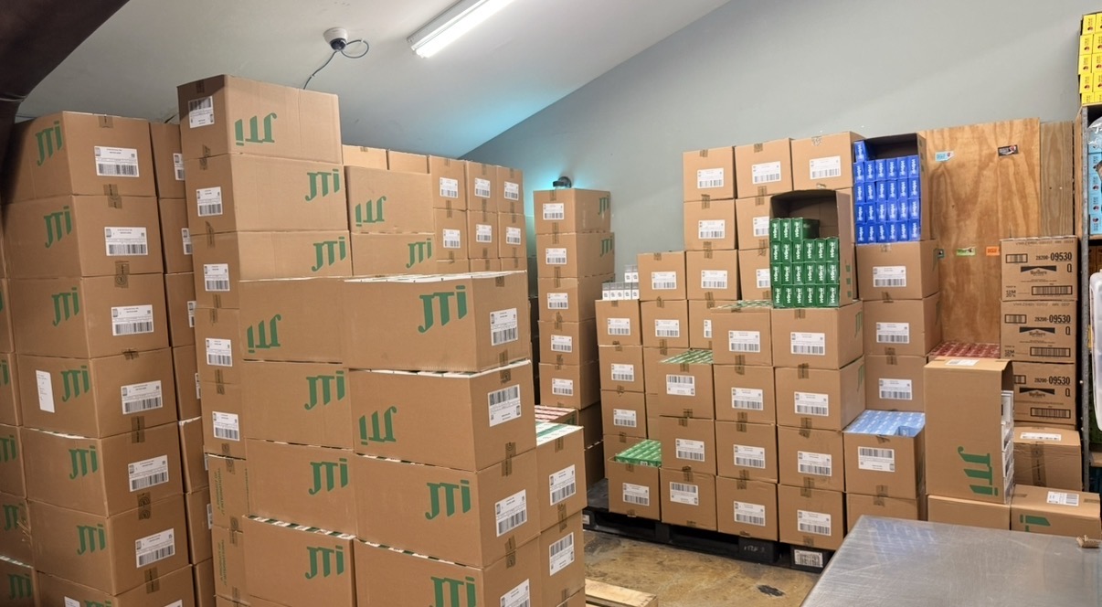 Cases of tobacco products stacked and ready for wholesale distribution inside Lambert's